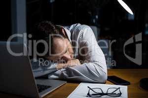 Tired businessman sleeping on the desk