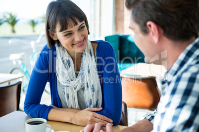 Couple talking to each other in coffee sho