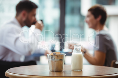 Milk bottle and bucket on table