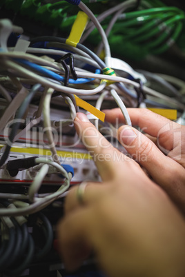 Technician analyzing rack mounted server