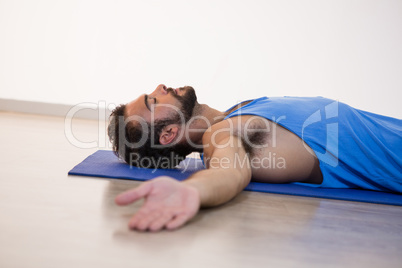 Man in yoga corpse pose