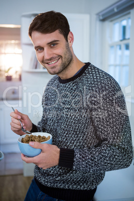 Portrait of man having cereal for breakfast