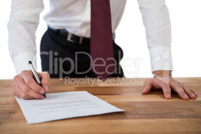 Businessman filling last will and testament form against white background