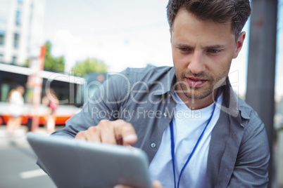 Handsome business executive using digital tablet