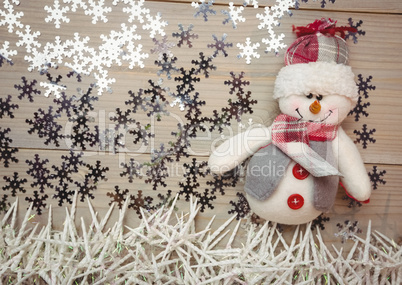 Snowman and christmas decoration on wooden table