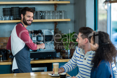Customer interacting with waiter in cafÃ?Â©