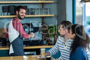 Customer interacting with waiter in cafÃ?Â©