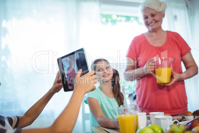 Boy photographing his grandmother and sister