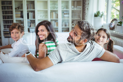 Happy family sitting on sofa