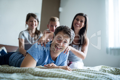 Family having fun in bedroom