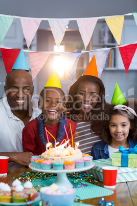 Portrait of family with birthday cake