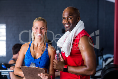 Portrait of happy fitness instructor with man