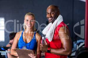 Portrait of happy fitness instructor with man