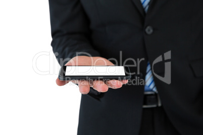 Mid section of businessman holding mobile phone