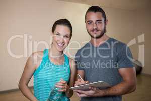 Portrait of smiling fitness trainer and woman