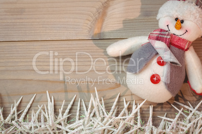 Snowman and small candles on wooden table