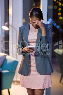 Businesswoman using mobile phone in office