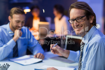 Businessman preparing document in conference room