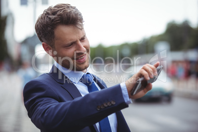 Handsome businessman holding mobile phone