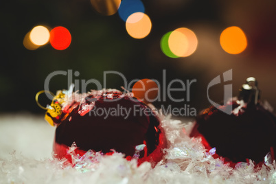 Close-up of christmas baubles on snow