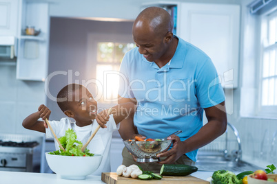 Father and son preparing food