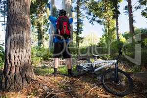 Excited mountain biker in forest