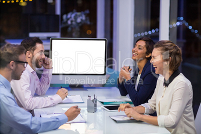 Businesspeople interacting with each other in conference room