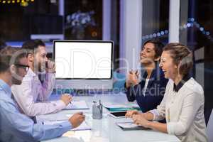 Businesspeople interacting with each other in conference room