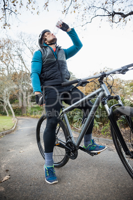 Male mountain biker drinking water