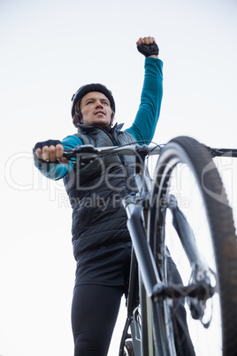 Excited mountain biker in forest