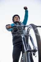 Excited mountain biker in forest