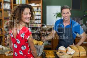 Smiling woman standing at bakery counter