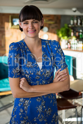 Portrait of smiling woman standing in the coffee shop