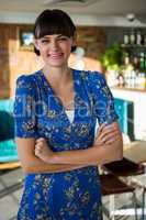 Portrait of smiling woman standing in the coffee shop