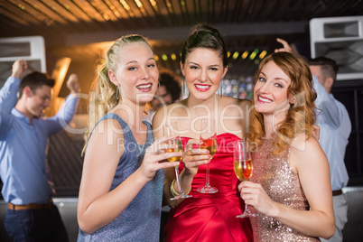 Portrait of female friends holding a glass of champagne