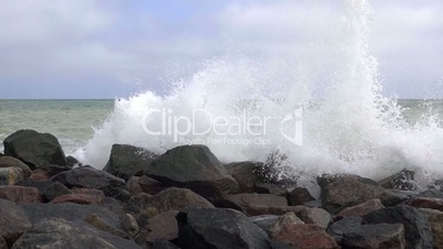 Spray of the Surf on the Rocky Seashore. Slow Motion