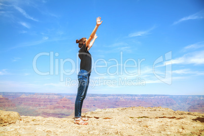 Young lady at the edge of the Grand Canyon rim