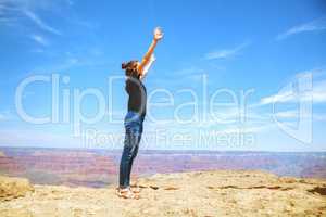 Young lady at the edge of the Grand Canyon rim