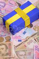 banknotes, clear image of dollars and new bills Ukrainian national currency hryvnia with gift box
