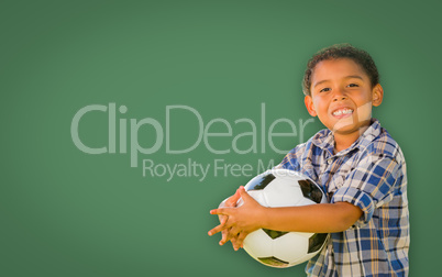 Cute Young Mixed Race Boy Holding Soccer Ball In Front of Blank