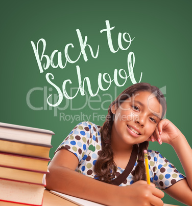 Cute Hispanic Girl Studying In Front of Back To School Written o