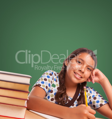 Cute Hispanic Girl StudyingIn Front of Blank Chalk Board