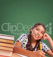 Cute Hispanic Girl StudyingIn Front of Blank Chalk Board