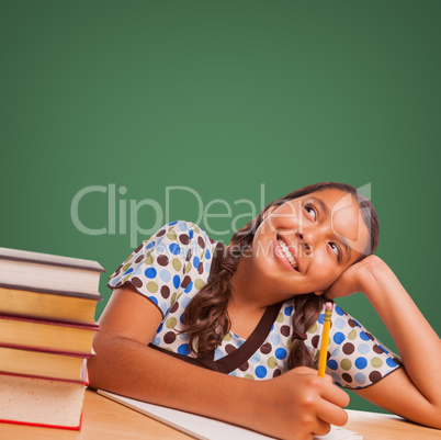 Cute Hispanic Girl Studying Looking Up to Blank Chalk Board