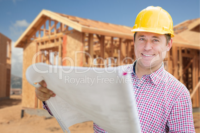 Contractor Wearing Hardhat Holding Blueprints at Home Constructi