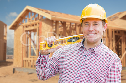 Contractor in Hardhat Holding Blueprints  and Level at Construct