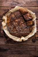 homemade chocolate brownie on dark wooden background, top view