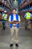 Warehouse worker holding clipboard