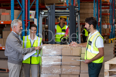 Warehouse manager and workers preparing a shipment