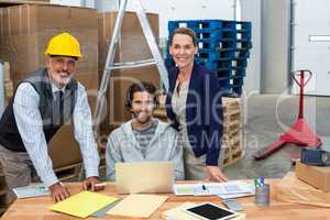 Portrait of warehouse managers and worker working together